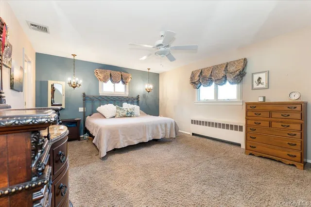 a bedroom with a bed and dresser