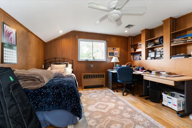a bedroom with a bed and a desk