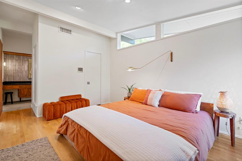 7320 Walling Lane Dallas, TX 75231 - Photo 21 of 40 a bedroom with bed and wooden floor