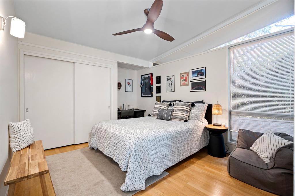 7320 Walling Lane Dallas, TX 75231 - Photo 23 of 40 a bedroom with a bed couch and a window