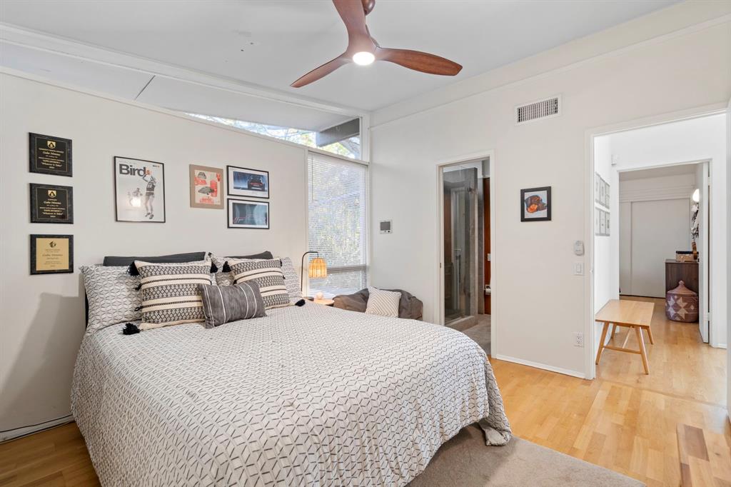 7320 Walling Lane Dallas, TX 75231 - Photo 24 of 40 a bedroom with double bed and a large mirror