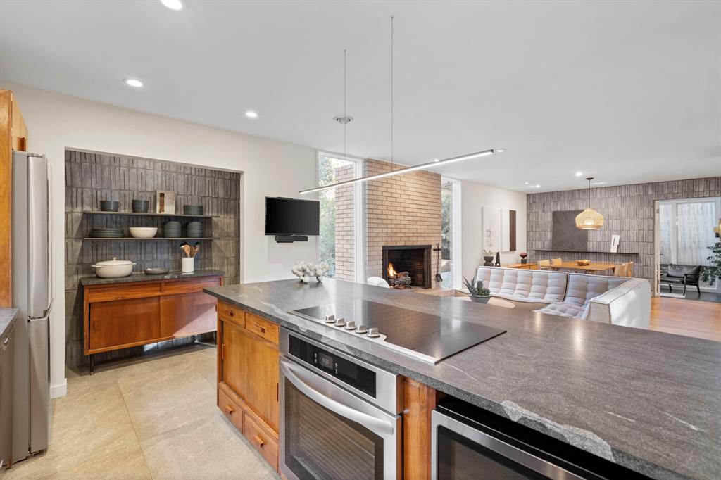 7320 Walling Lane Dallas, TX 75231 - Photo 6 of 40 a large kitchen with stainless steel appliances and a view of living room