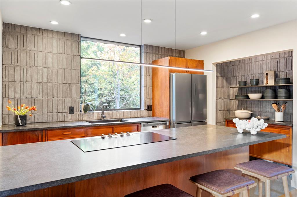 7320 Walling Lane Dallas, TX 75231 - Photo 8 of 40 a kitchen with stainless steel appliances granite countertop a sink and a refrigerator