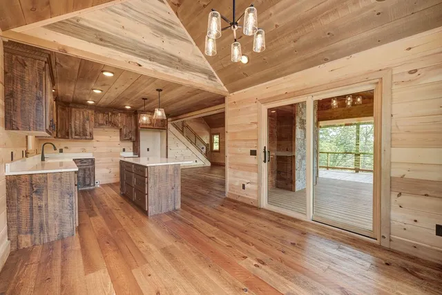 wooden floor fireplace and windows in an empty room
