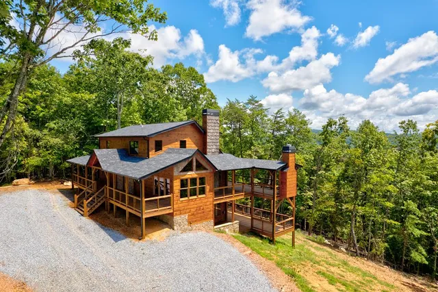 a view of a room with wooden floor and ceiling fan