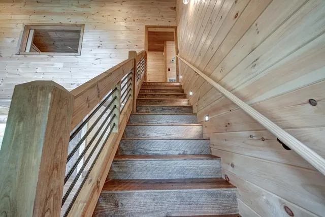 a large kitchen with stainless steel appliances granite countertop a lot of counter space and a wooden floors