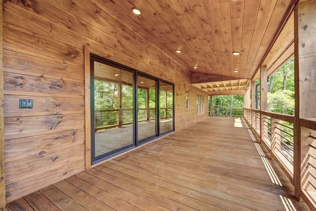 a view of a kitchen with furniture and wooden floor