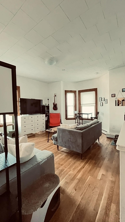 3 Nira Avenue, Unit 2 Boston, MA 02130 - Photo 3 of 9 a living room with furniture and a wooden floor