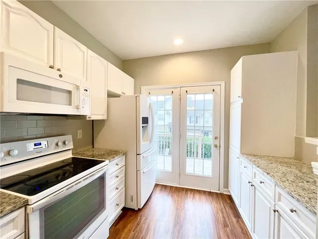 a kitchen with a stove a sink and a refrigerator