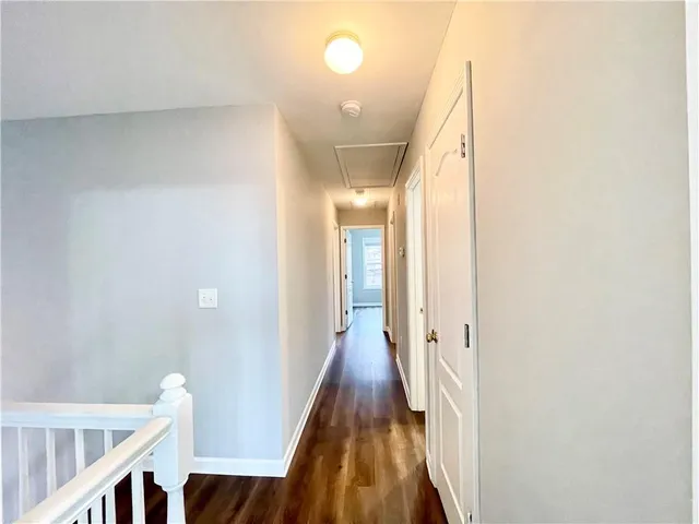 a view of hallway with wooden floor