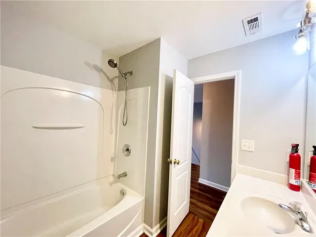 a bathroom with a tub and shower