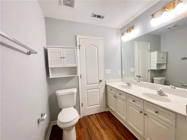 a bathroom with a sink toilet and a mirror