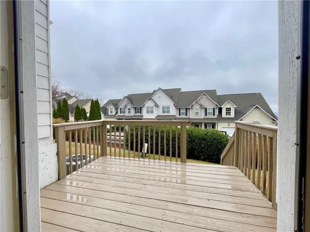 a view of a street with wooden fence