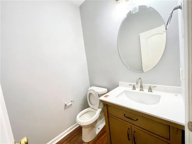 a bathroom with a sink mirror and toilet