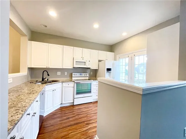 a kitchen with a sink a window and appliances