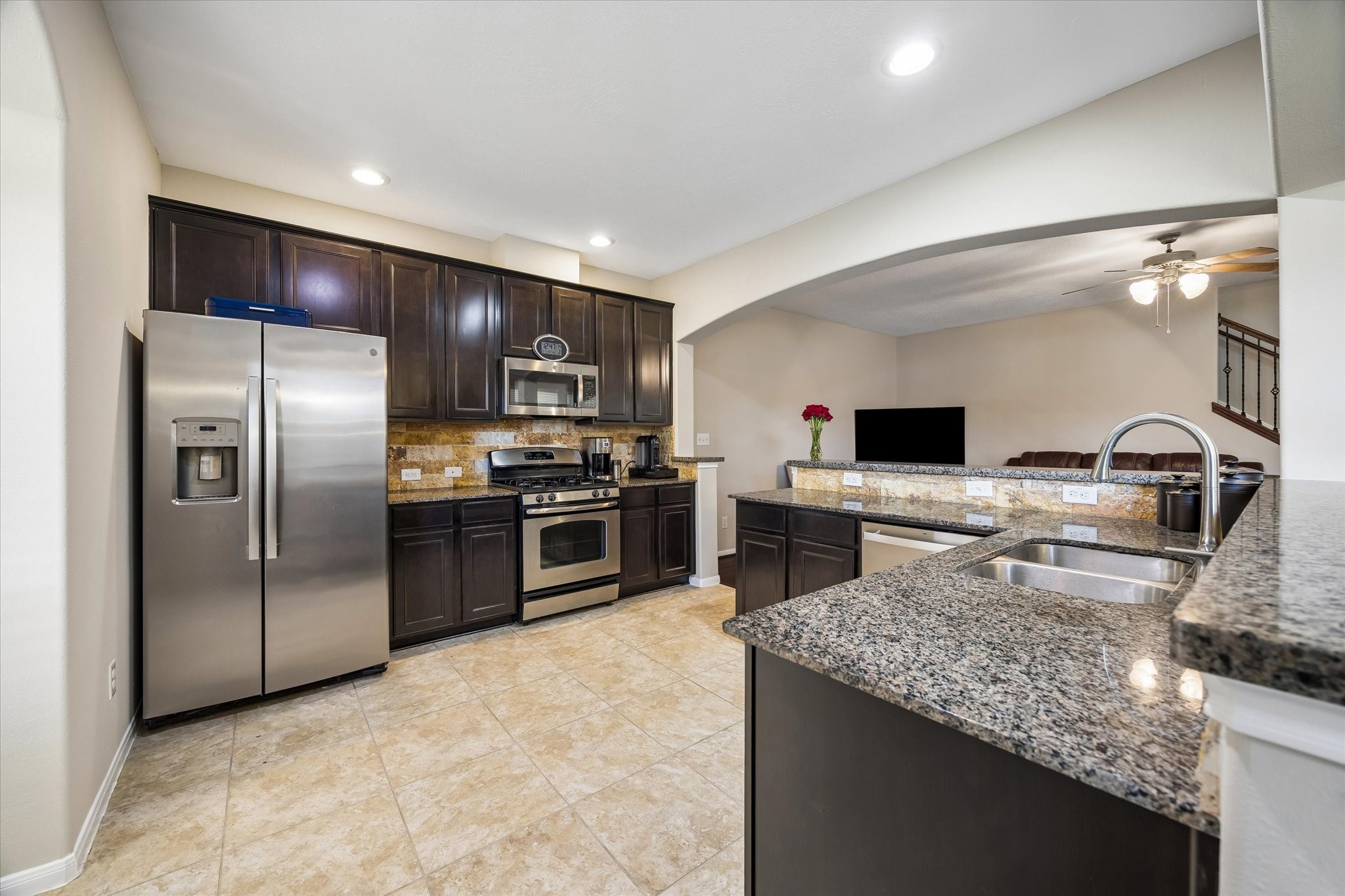 8433 Sunset Loch Drive Spring, TX 77379 - Photo 11 of 25 a kitchen with kitchen island a sink stainless steel appliances and a counter top space
