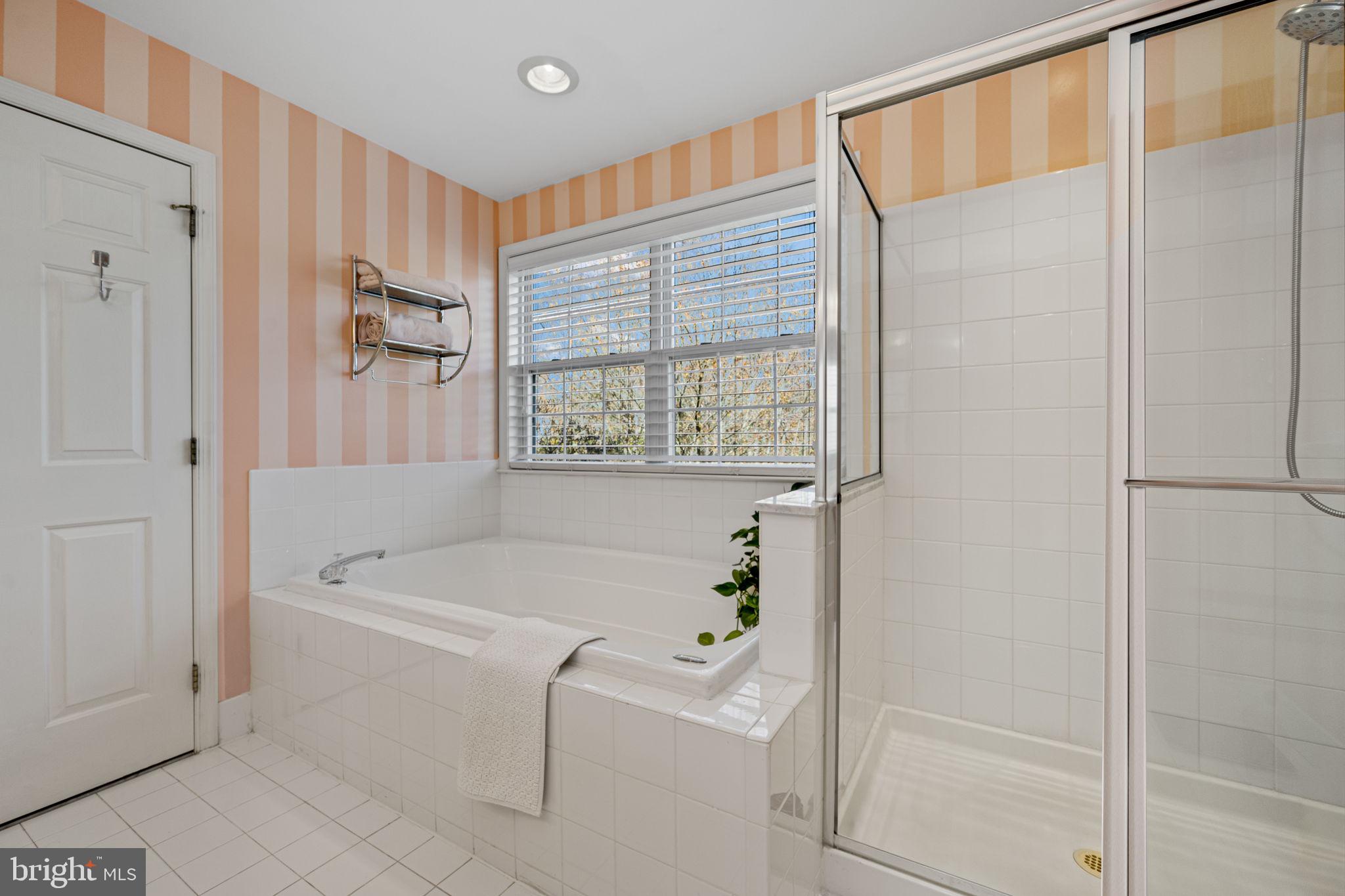 24 Longview Lane Newtown Square, PA 19073 - Photo 18 of 32 a bathroom with a bathtub a shower and a window