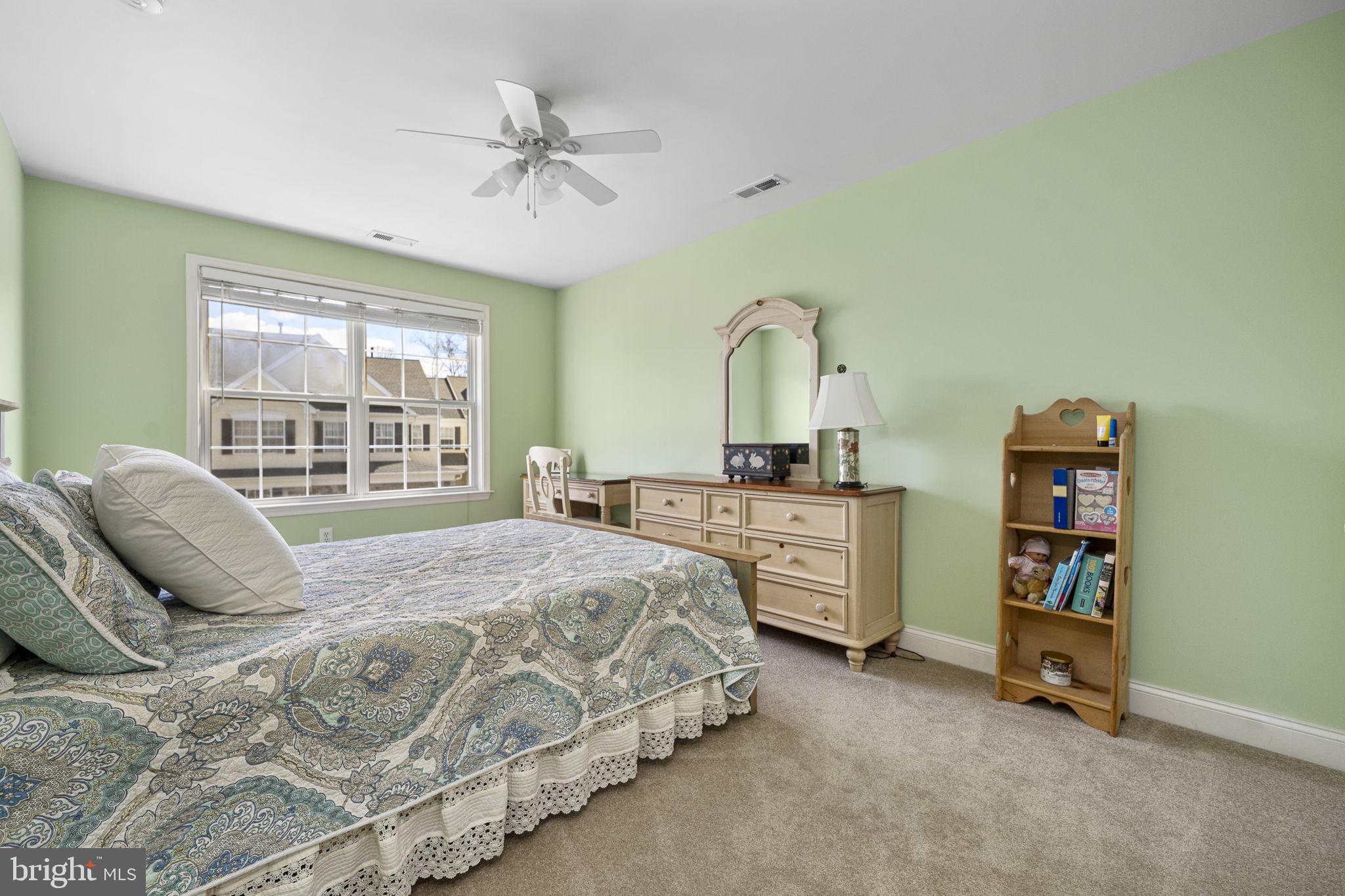 24 Longview Lane Newtown Square, PA 19073 - Photo 20 of 32 a bedroom with a bed a dresser and a large window