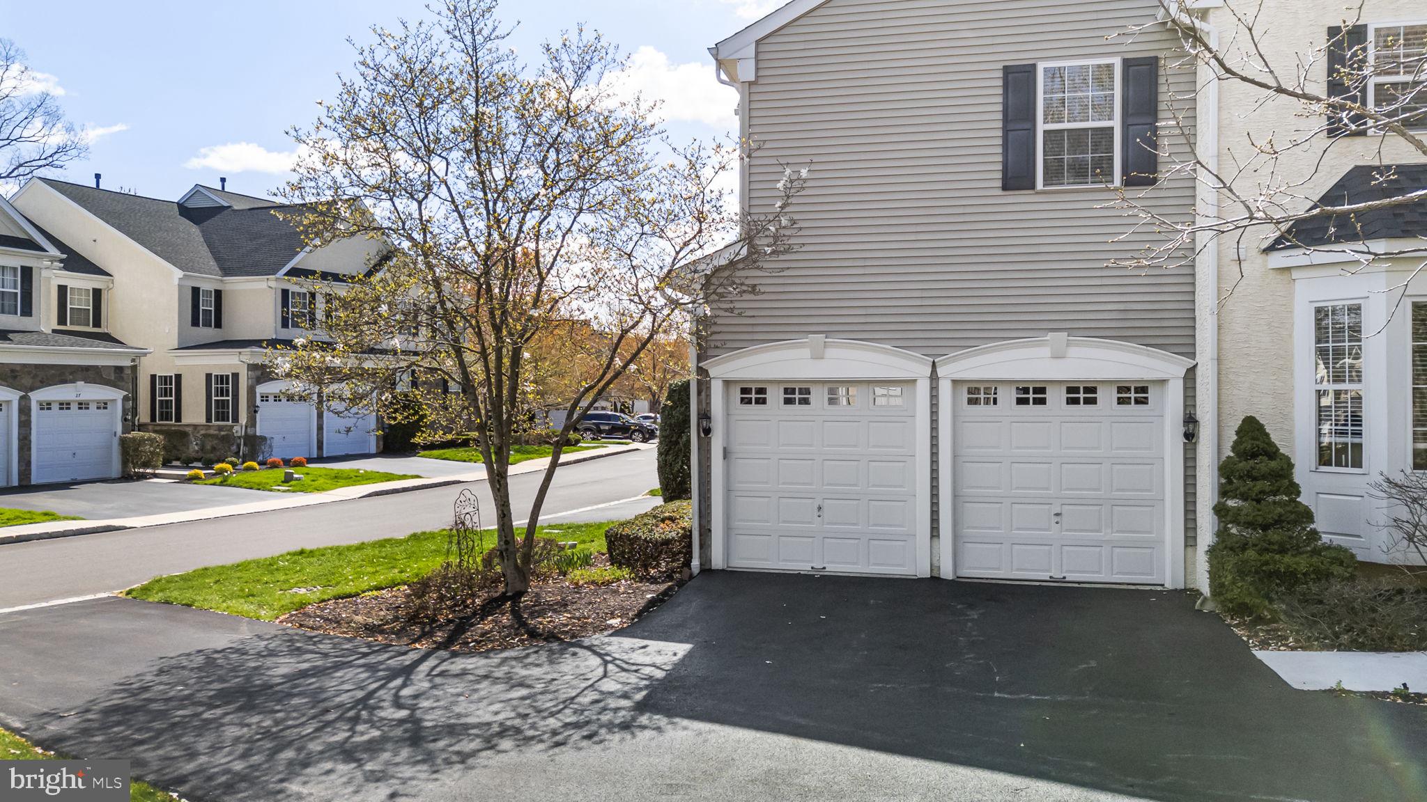 24 Longview Lane Newtown Square, PA 19073 - Photo 30 of 32 a front view of a house with a yard and garage