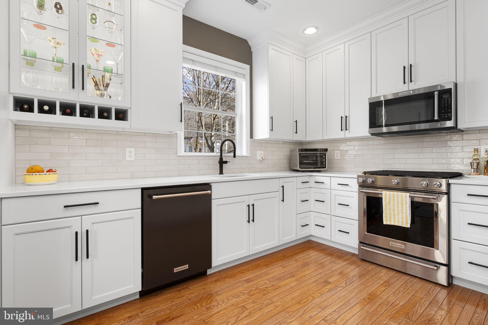 24 Longview Lane Newtown Square, PA 19073 - Photo 5 of 32 a kitchen with stainless steel appliances white cabinets and a stove a oven with wooden floor