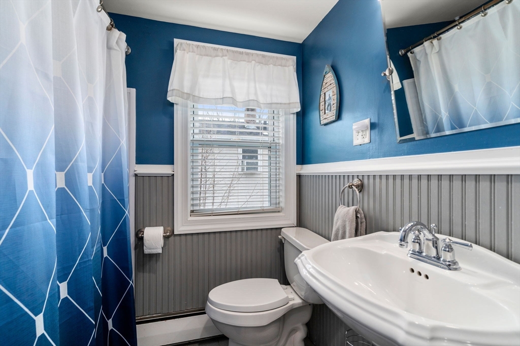 15 Farrin Street Boston, MA 02136 - Photo 15 of 22 a bathroom with a sink a toilet and a mirror