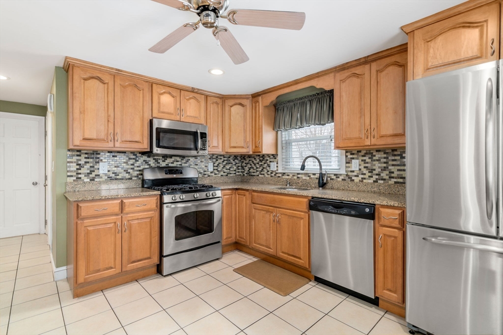 15 Farrin Street Boston, MA 02136 - Photo 3 of 22 a kitchen with stainless steel appliances granite countertop a refrigerator stove microwave and sink