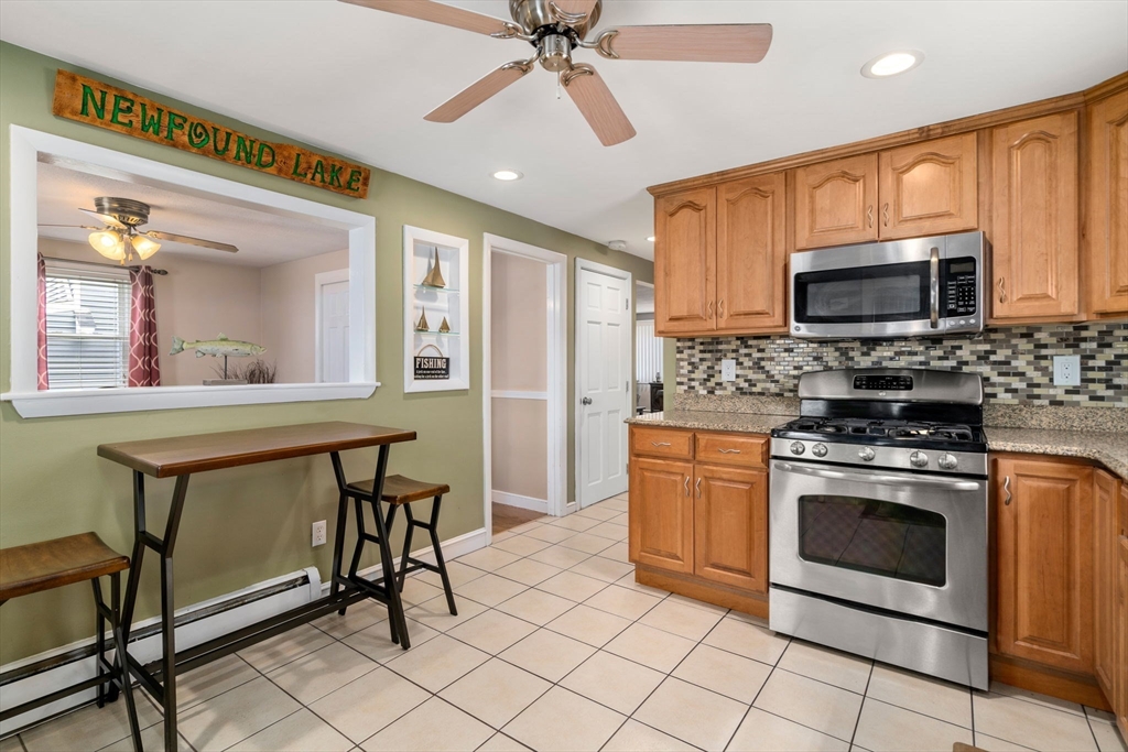 15 Farrin Street Boston, MA 02136 - Photo 4 of 22 a kitchen with stainless steel appliances granite countertop a stove a sink and a microwave