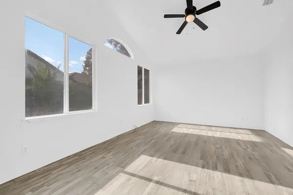 a view of a room with wooden floor and white walls