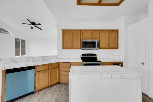a kitchen with a sink a microwave and cabinets