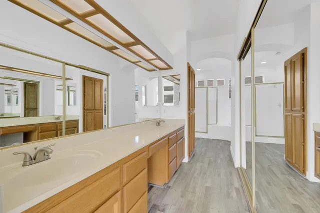 a spacious bathroom with a tub sink and mirror