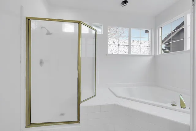 a bathroom with a bathtub and a shower
