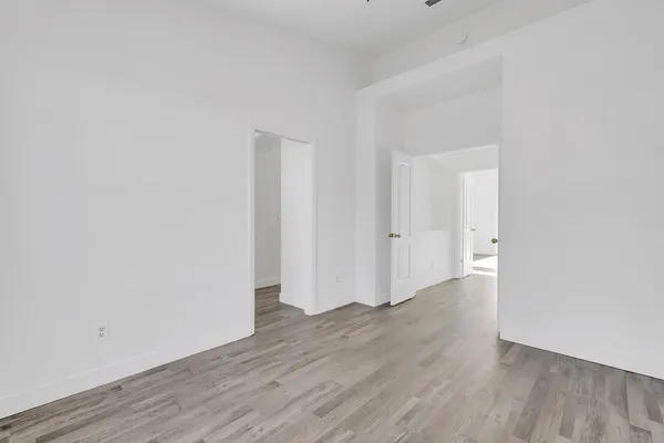 a view of a room with wooden floor