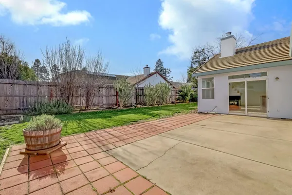 a view of a porch with a chairs and plants