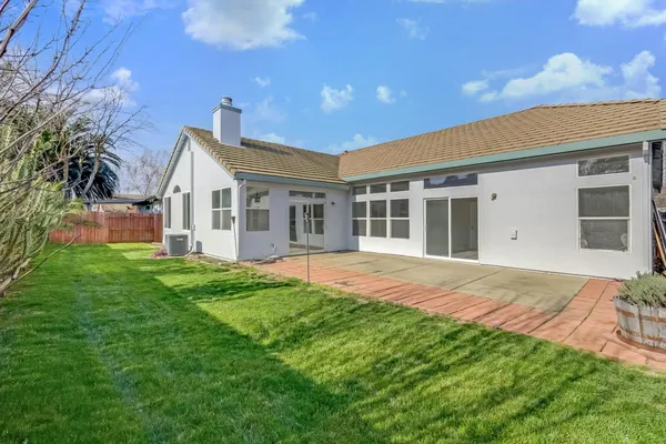 a view of a house with a backyard