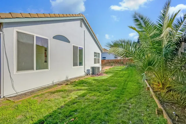 a view of a house with a small yard and plants