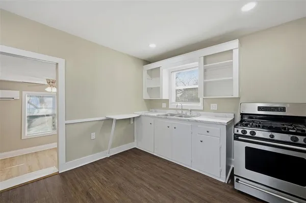 a kitchen with granite countertop a stove and a sink