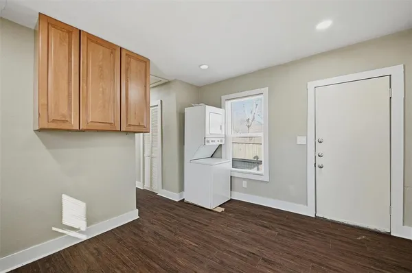 a view of a kitchen with wooden floor and electronic appliances