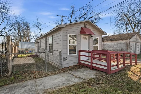 a front view of a house with a yard and a garage