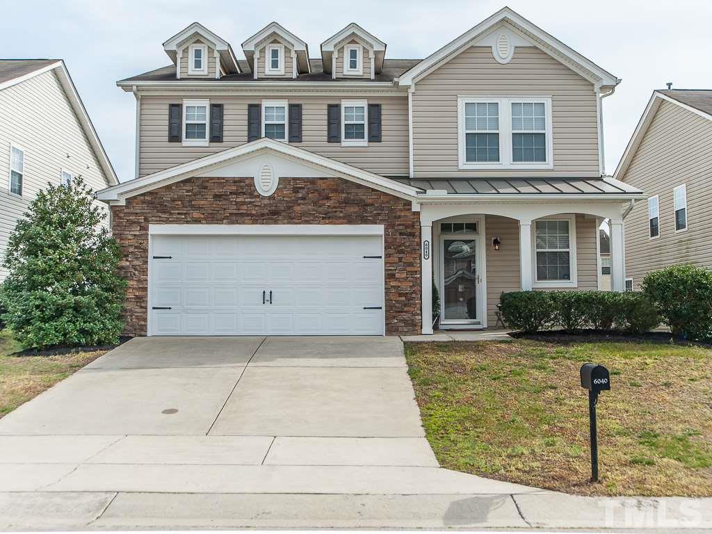 6040 Ricker Road Raleigh, NC 27610 - Photo 1 of 25 a front view of a house with garden