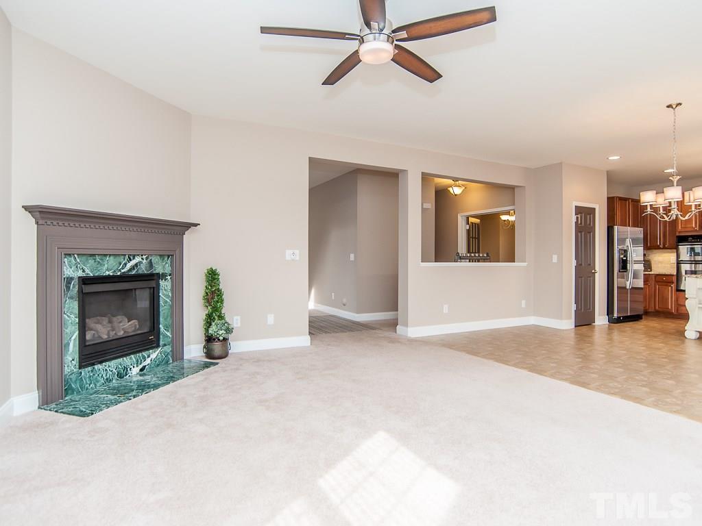 6040 Ricker Road Raleigh, NC 27610 - Photo 11 of 25 a view of a livingroom with a fireplace and window