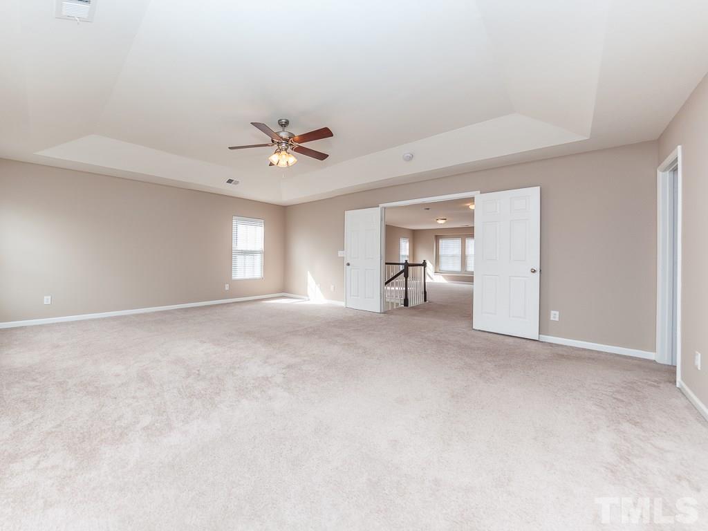 6040 Ricker Road Raleigh, NC 27610 - Photo 17 of 25 a view of a livingroom with a ceiling fan and window