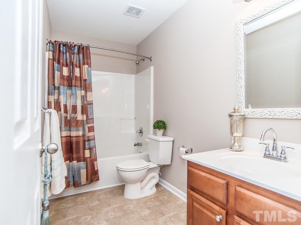 6040 Ricker Road Raleigh, NC 27610 - Photo 22 of 25 a bathroom with a sink toilet and shower