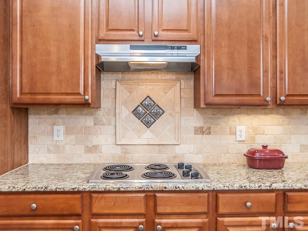 6040 Ricker Road Raleigh, NC 27610 - Photo 6 of 25 a kitchen with granite countertop cabinets and utility wooden floor