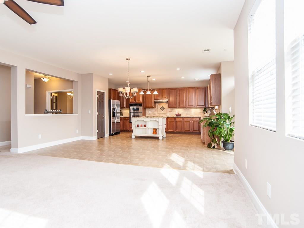 6040 Ricker Road Raleigh, NC 27610 - Photo 9 of 25 a living room with furniture and a potted plant
