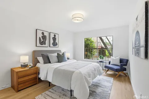 a bedroom with a bed and a large window