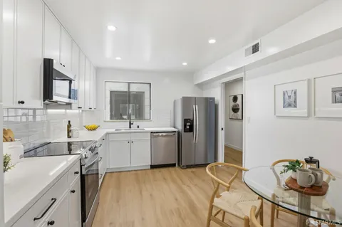 a kitchen with a refrigerator and a sink