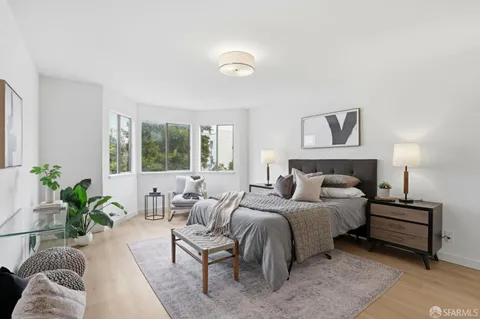 a bedroom with a bed and a couch