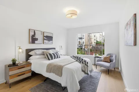 a bedroom with a bed and a couch