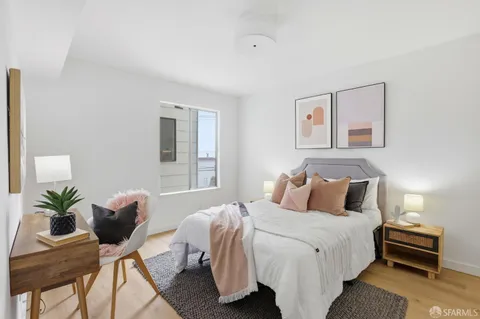 a bedroom with a bed and a potted plant