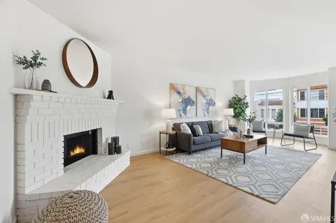 a living room with furniture a fireplace and a table